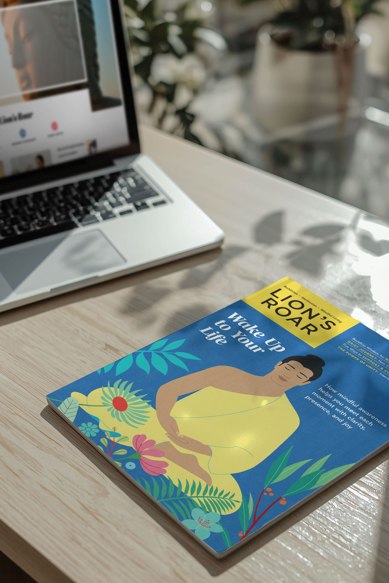 Lion‘s Roar Magazine on a computer desk in soft light